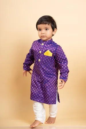 Vibrant purple kurta with golden motifs and yellow pocket square, paired with classic white churidar pants for festive elegance