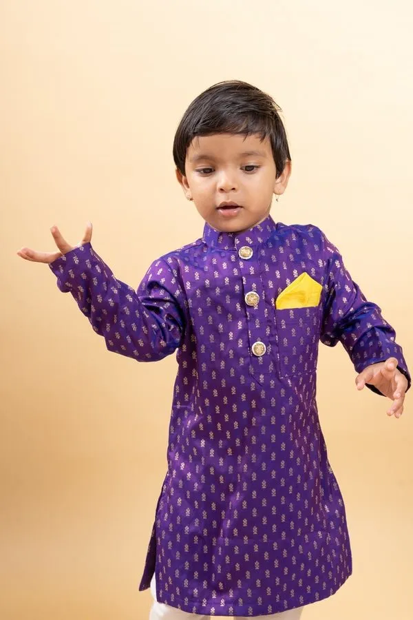 Vibrant purple kurta with golden motifs and yellow pocket square, paired with classic white churidar pants for festive elegance